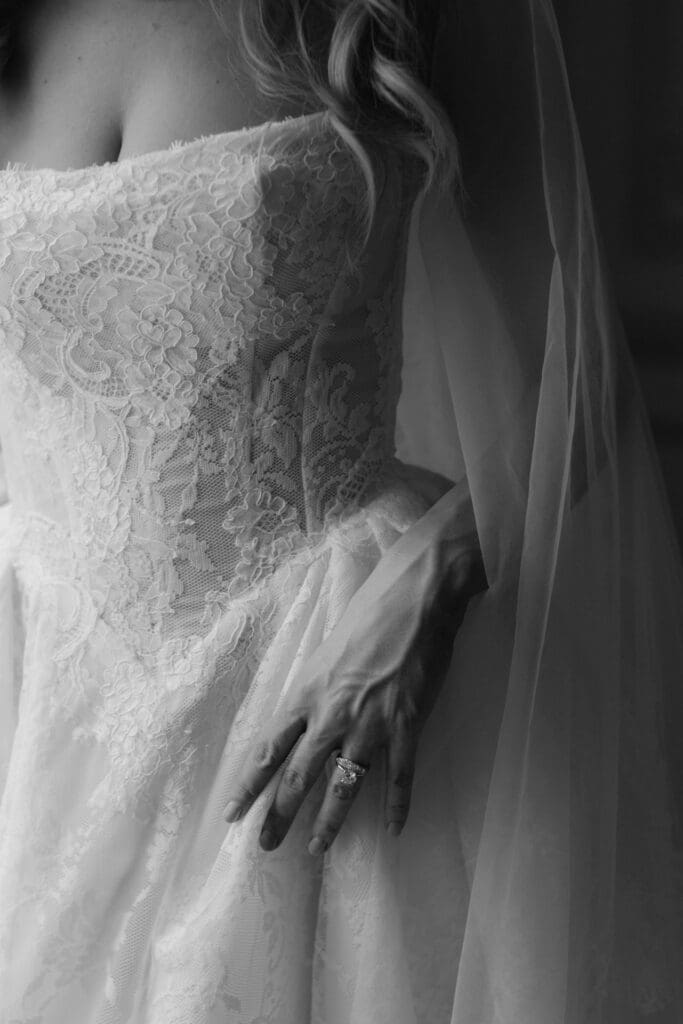 closeup shot of the wedding ring and wedding dress