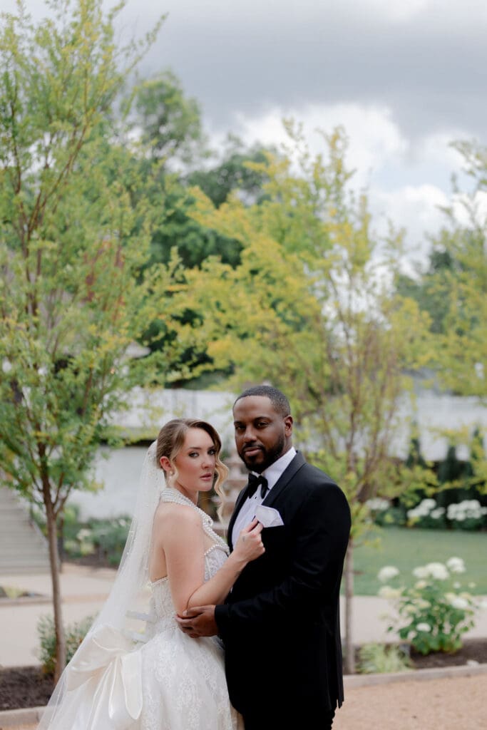 portrait of the newlyweds smiling at the camera during their photoshoot