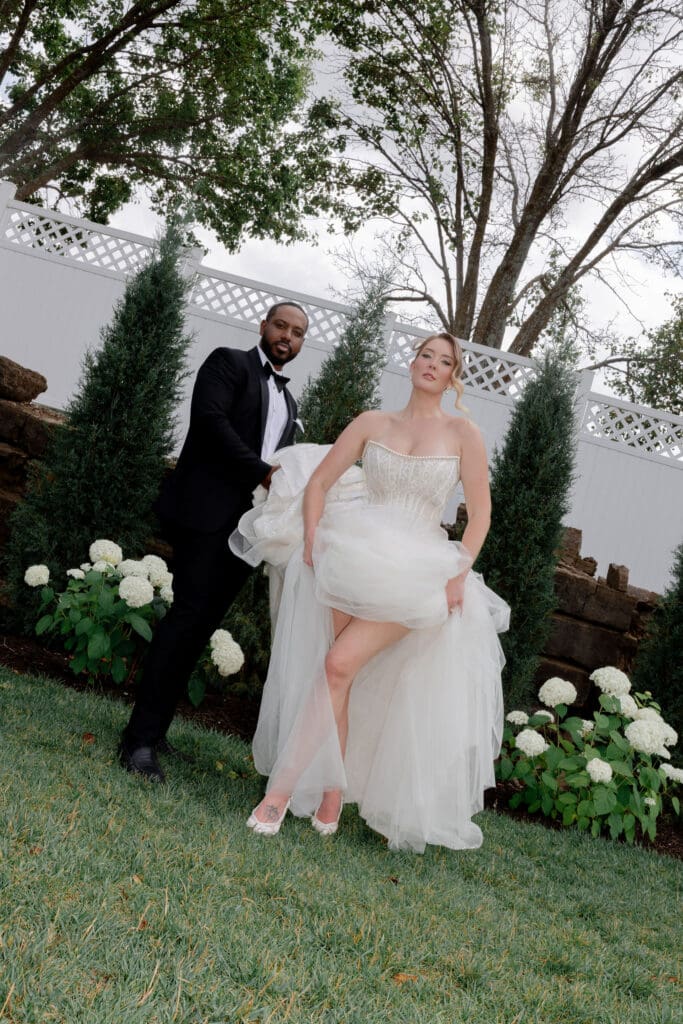 newlyweds smiling at the camera during their photoshoot