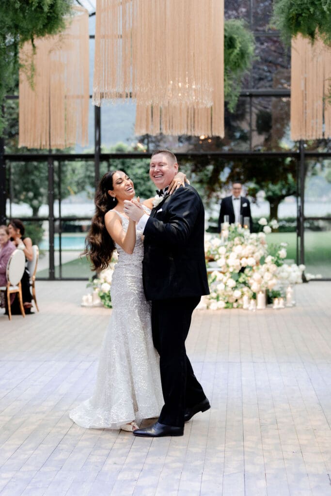 newlyweds laughing with each other at their wedding reception