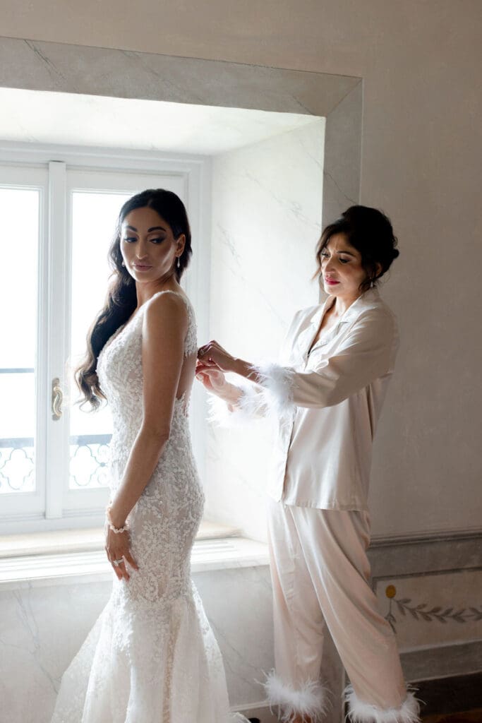 mother of the bride, helping her with the wedding dress